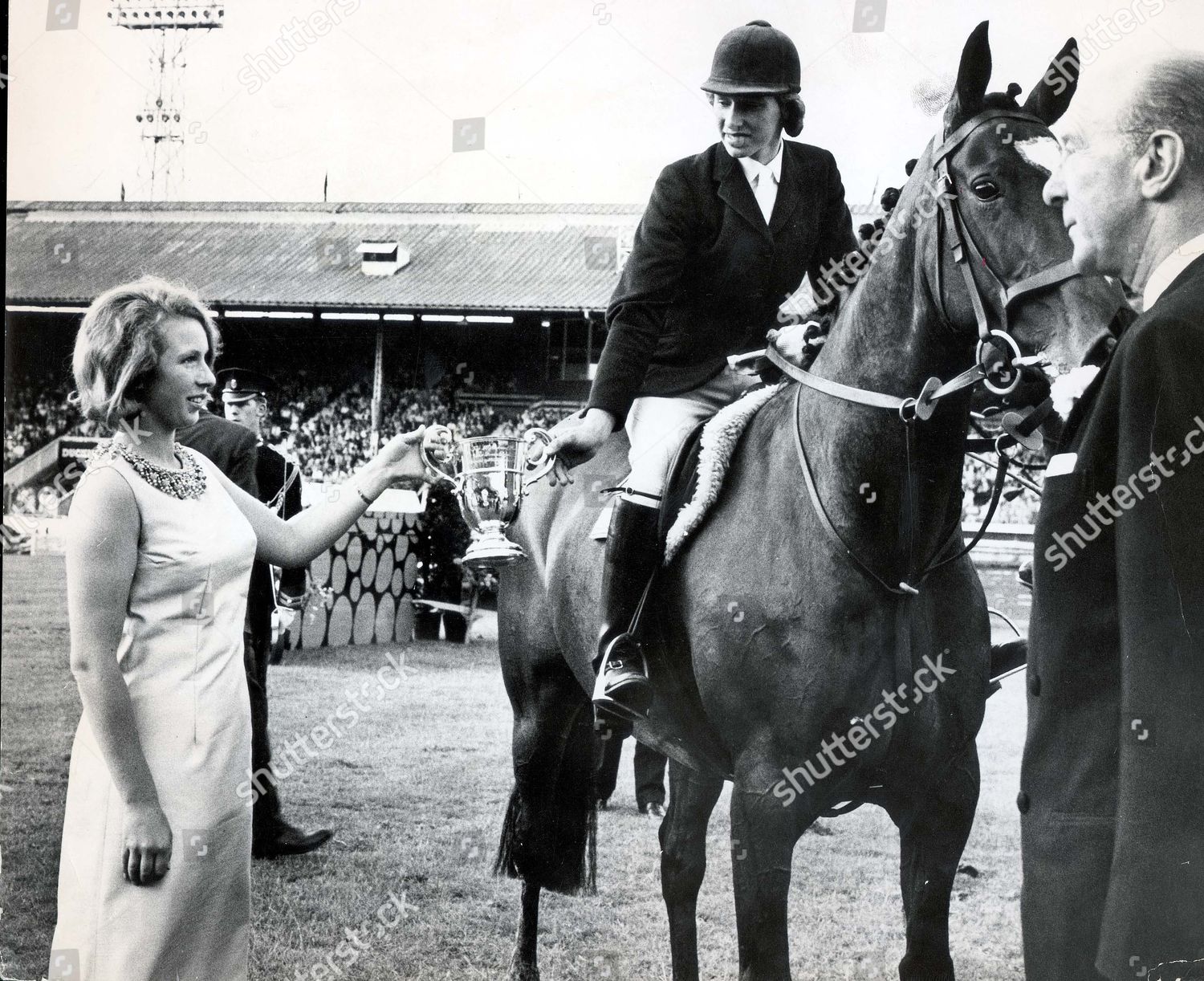 princess-anne-now-princess-royal-july-1967-july-1967-betty-jennaway-looks-on-from-the-saddle-as-princess-anne-attaches-the-victory-rosette-to-her-horse-grey-leg-betty-and-grey-leg-had-just-won-the-queen-elizabeth-ii-cup-at-the-royal-international-shutterstock-editorial-890805a.jpg