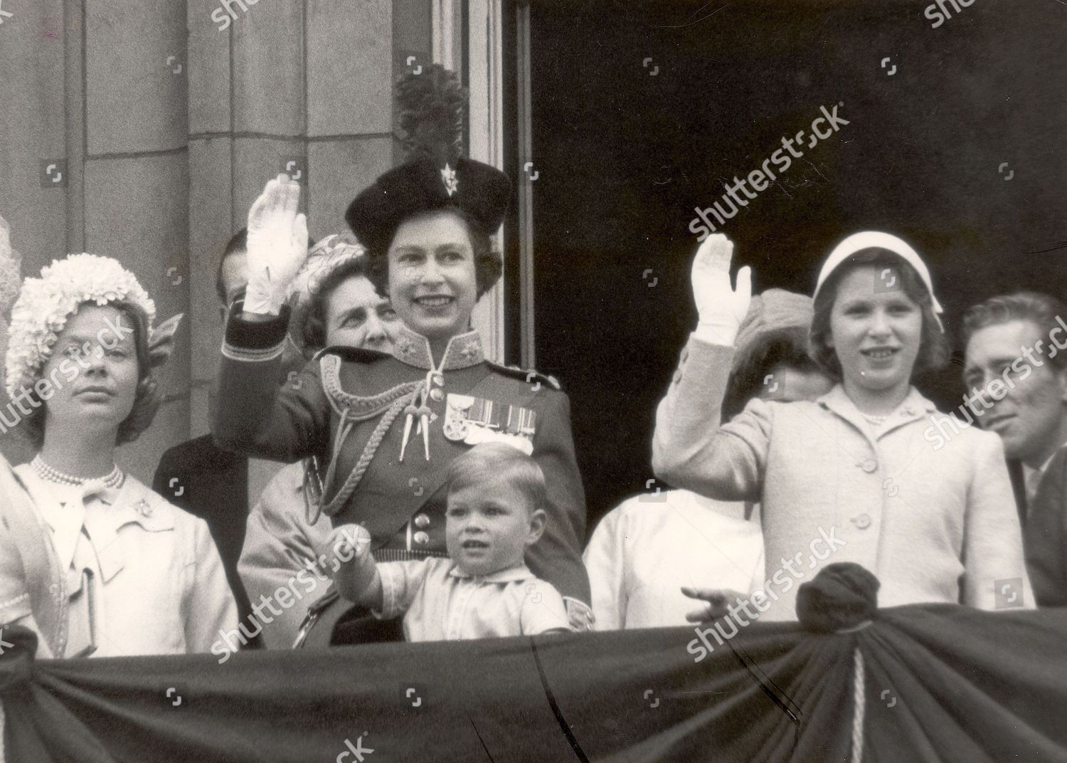 queen-elizabeth-ii-with-prince-andrew-now-the-duke-of-york-waving-from-the-balcony-with-princess-anne-now-the-princess-royal-right-the-duchess-of-kent-left-and-anthony-armstrong-jones-now-lord-snowdon-after-the-trooping-the-colour-ceremony-in-196-shutterstock-editorial-896143a.jpg