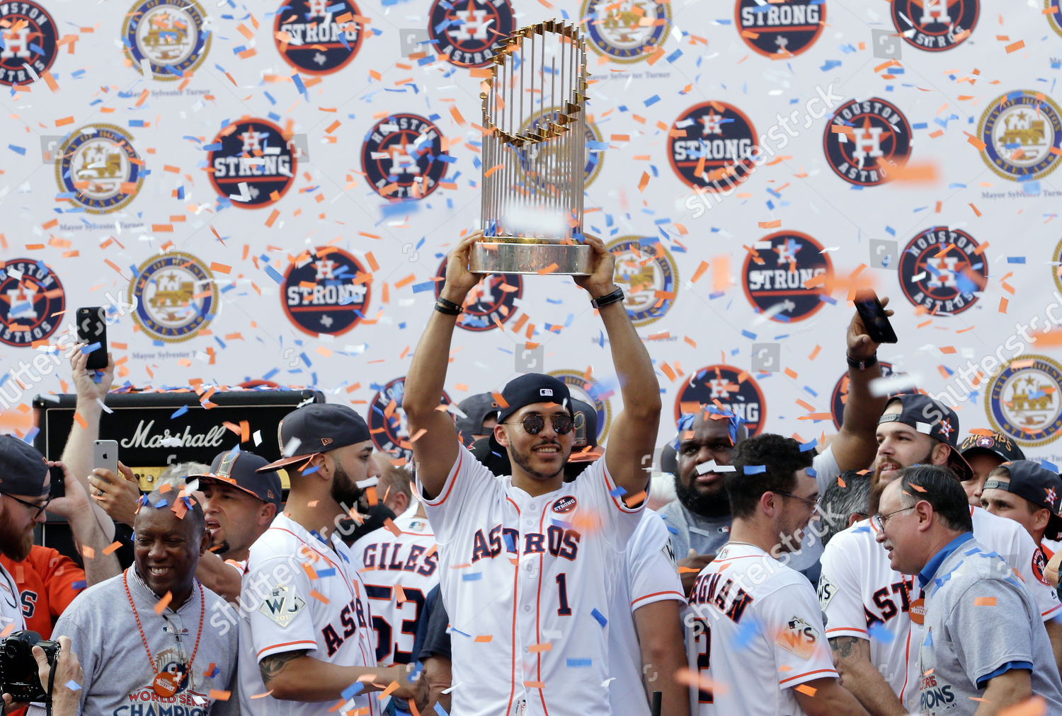 Houston Astros shortstop Carlos Correa hoists the World Series championship  trophy as he walks on the st…