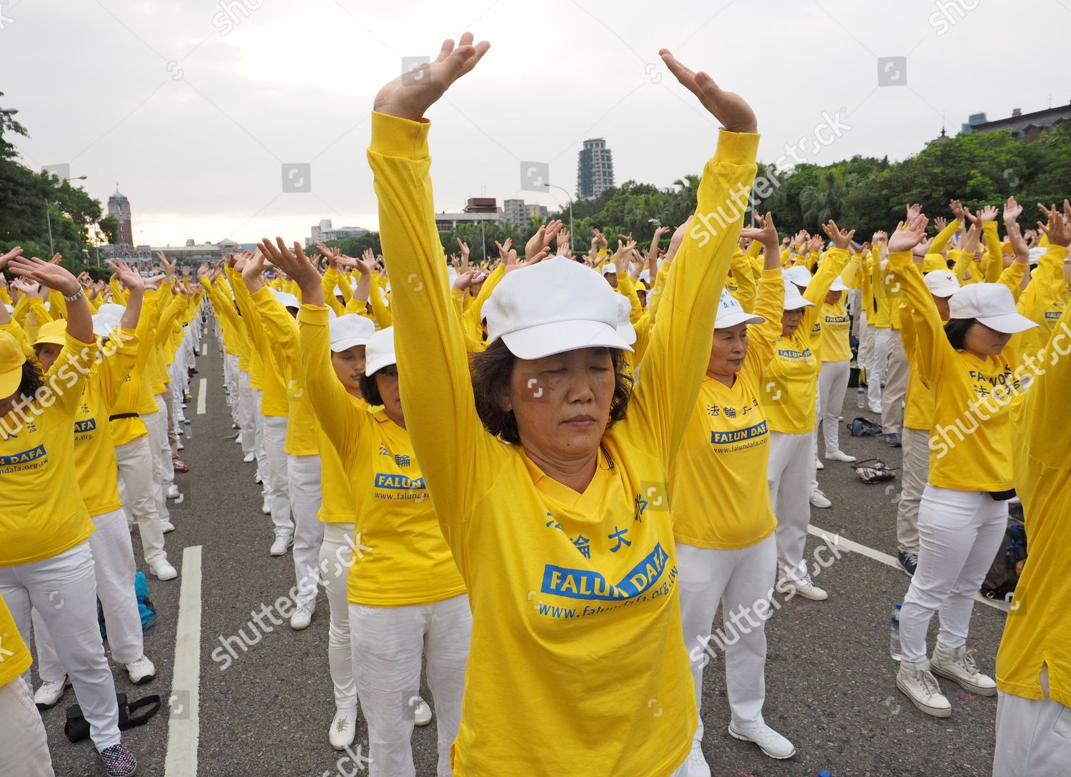 Falun Gong practitioners wearing shirts reading Falun Editorial ...