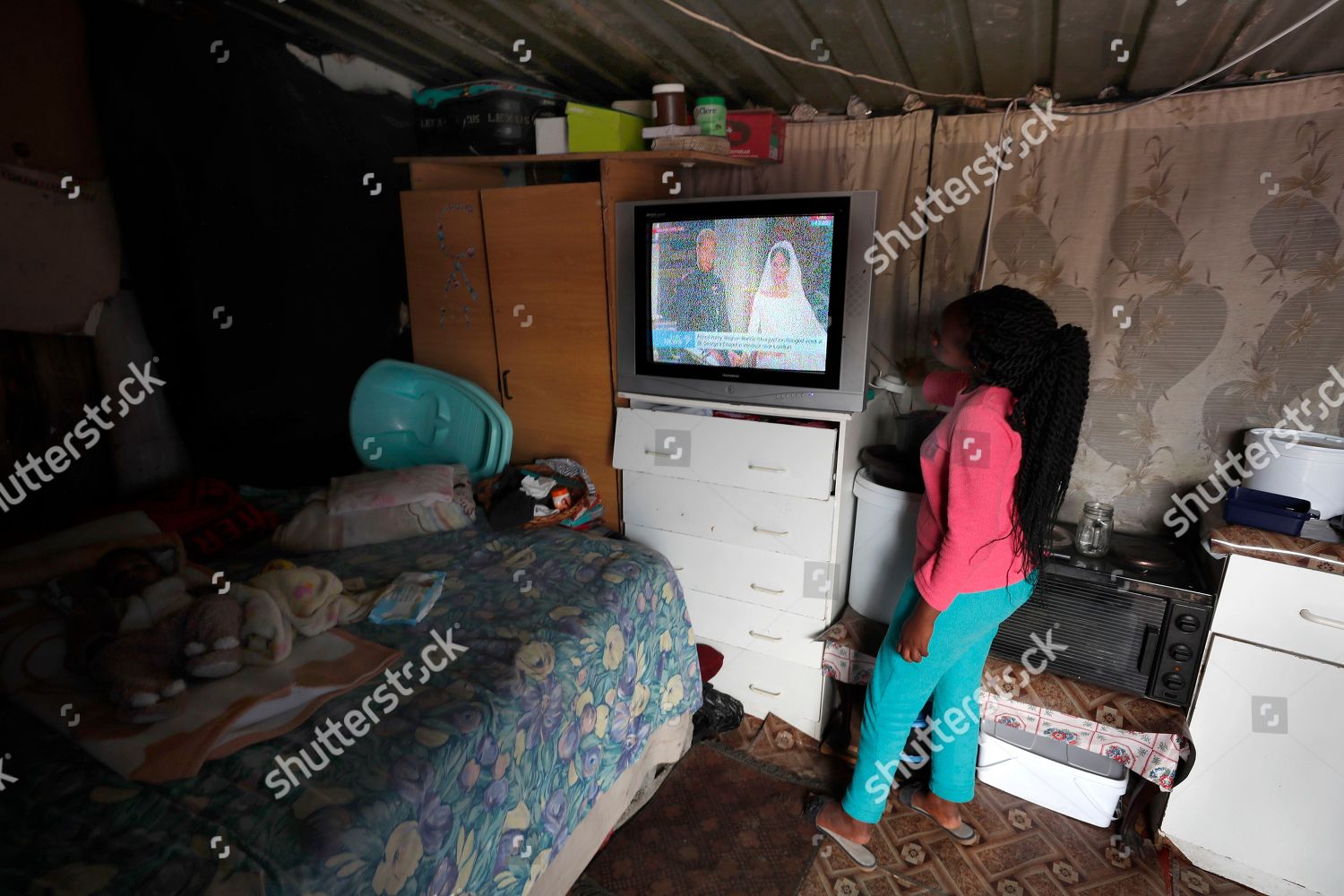 South African Mother Adjusts Television Antennae Improve