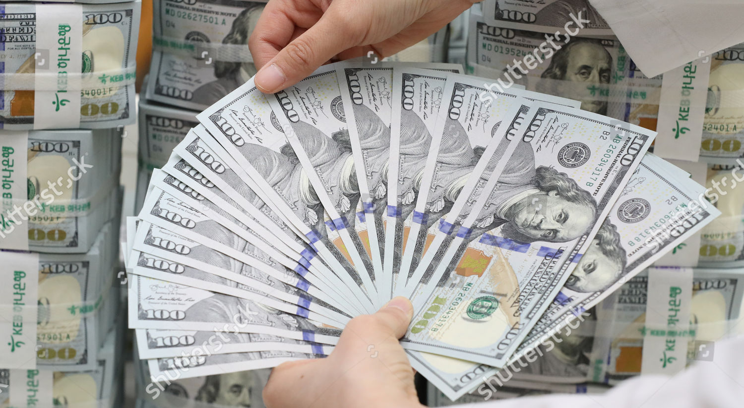 Clerk Scrutinizes 100dollar Us Banknotes Counterfeits Headquarters - 