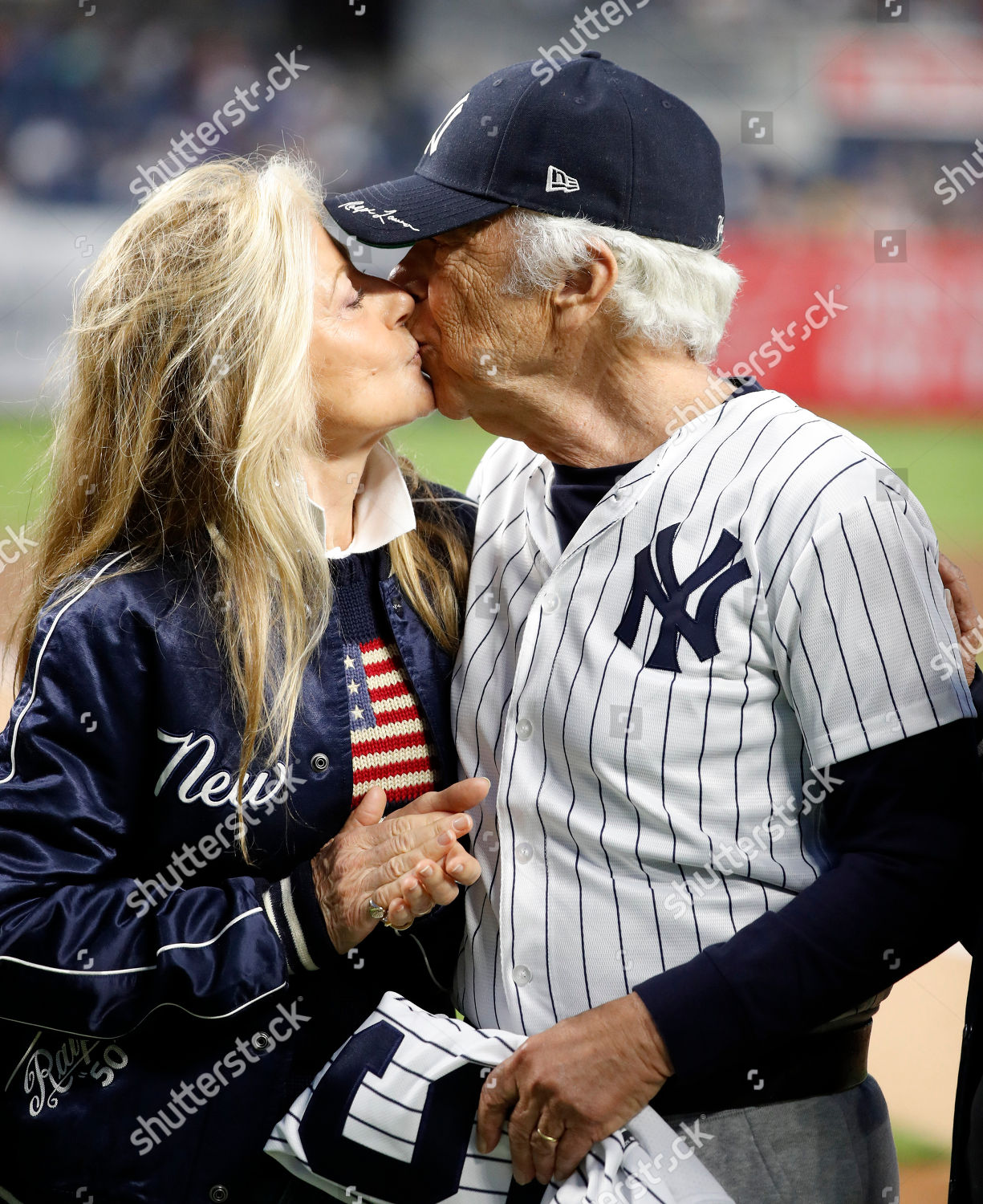 Fashion designer Ralph Lauren (L) kisses his wife Ricky Lauren on