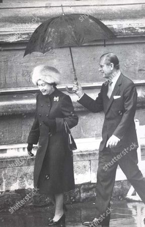 christmas-day-at-windsor-queen-elizabeth-ii-and-prince-philip-the-duke-of-edinburgh-shelter-under-an-umbrella-at-st-georges-in-windsor-after-the-traditional-christmas-sdervice-a-hussar-hatted-princess-diana-led-the-fashion-parade-at-the-traditiona-h-shutterstock-editorial-1044524a.jpg