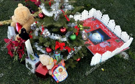 christmas theme decorations and gifts adorn the grave of a boy at the inglewood park cemetery - Christmas Grave Decorations christmas theme decorations and gifts adorn the grave of a boy at the inglewood park cemetery - Christmas Grave Decorations