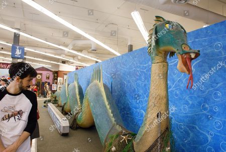 Visitor Looks Over Animatronic Sea Serpent During Editorial Stock