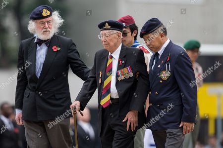 Hong Kong Veterans Walk After Laying Wreaths In Front Of The Cenotaph In Hong Kong Hong Kong Veterans Walk After Laying Wreaths In Front Of The Cenotaph In Hong Kong